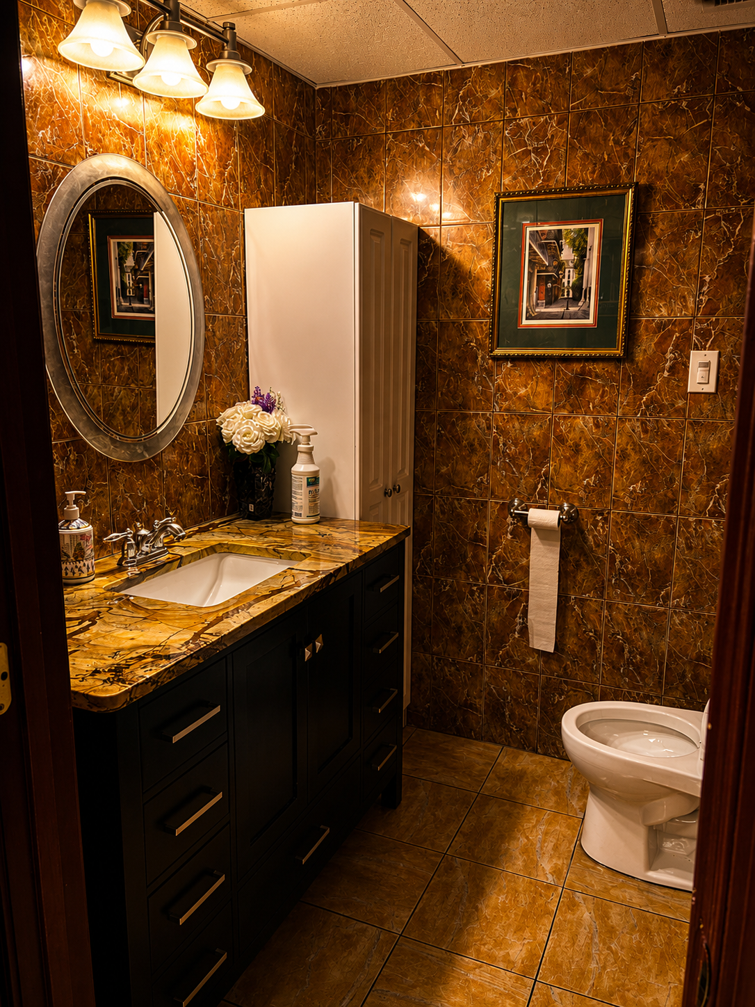 Refined bathroom interior with marble-pattern walls and vanity at Gentlemen's Cue Club