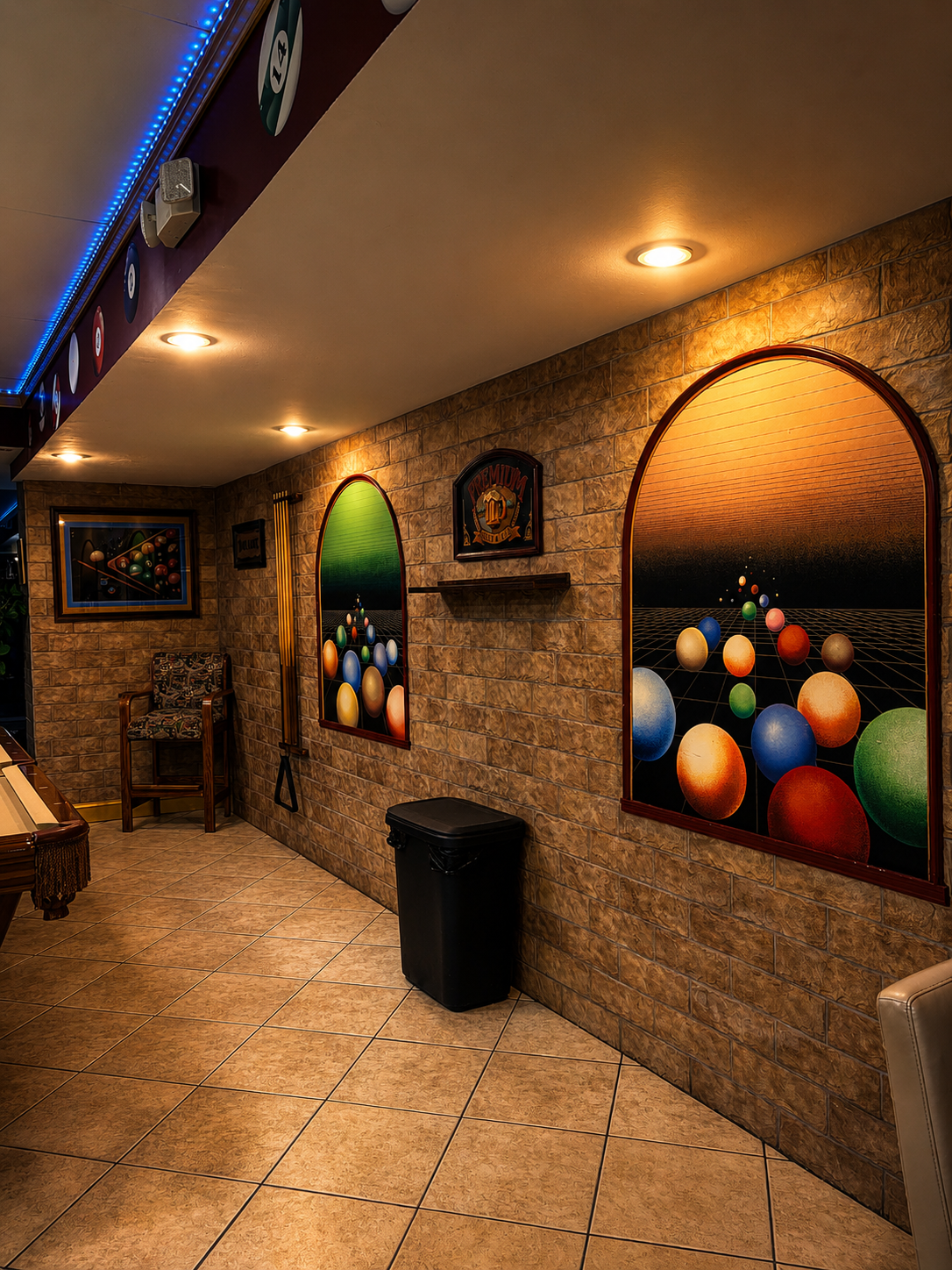 Decorative arched wall art and lounge corner inside Gentlemen's Cue Club